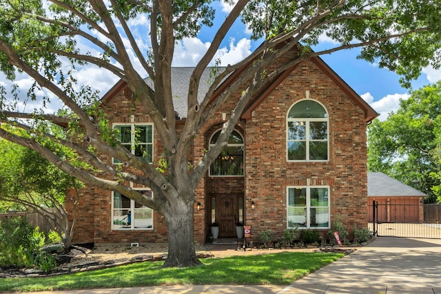 3252 Shady Glen Dr, Grapevine, TX 76051 - view of front facade with brick siding, a gate, a shingled roof, and driveway