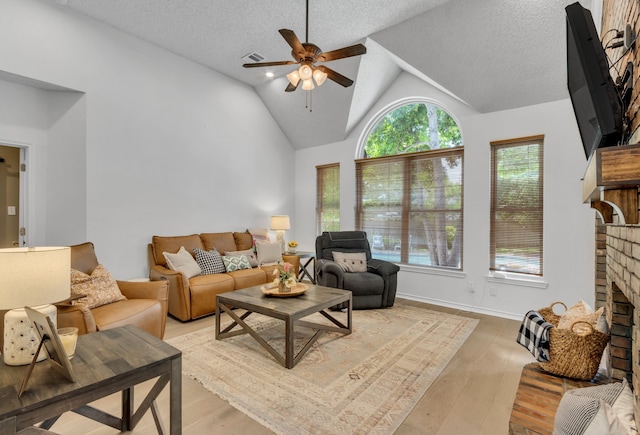 3252 Shady Glen Dr, Grapevine, TX 76051 - living area featuring a brick fireplace, plenty of natural light, ceiling fan, light wood-style floors, and lofted ceiling