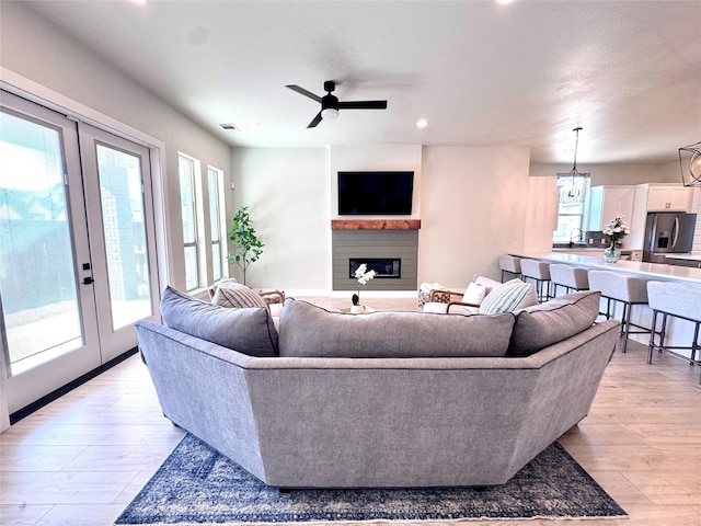 2402 Amesbury Dr, Midlothian, TX 76065 - living area featuring french doors, a fireplace, light wood-style floors, a ceiling fan, and recessed lighting