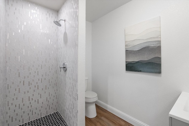 2800 Broadacres Ln, Dalworthington Gardens, TX 76016 - bathroom featuring tiled shower, wood finished floors, and vanity