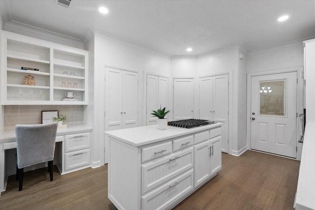 2800 Broadacres Ln, Dalworthington Gardens, TX 76016 - kitchen with crown molding, dark wood finished floors, white cabinetry, stainless steel gas cooktop, and light countertops
