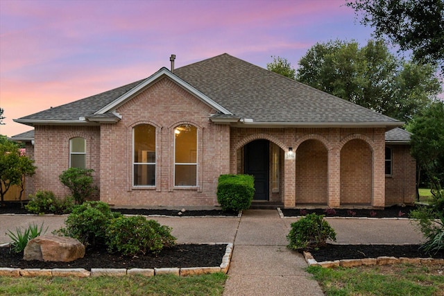 2800 Broadacres Ln, Dalworthington Gardens, TX 76016 - french country style house featuring roof with shingles, brick siding, and a porch