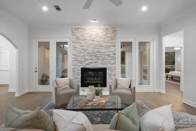 2800 Broadacres Ln, Dalworthington Gardens, TX 76016 - living area with ornamental molding, wood finished floors, arched walkways, a ceiling fan, and a stone fireplace