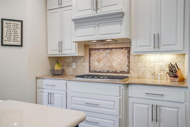 306 Creekview Ter, Aledo, TX 76008 - kitchen with stainless steel gas cooktop, white cabinets, tasteful backsplash, custom range hood, and light stone counters