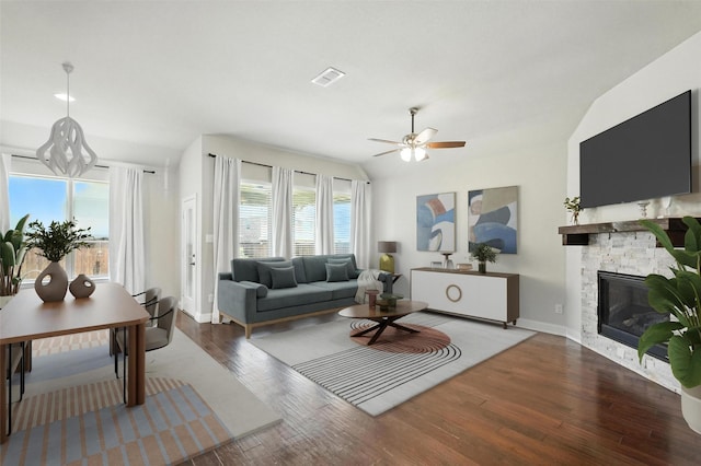 7508 Guadalupe Way, Mckinney, TX 75071 - living room featuring wood finished floors, a stone fireplace, ceiling fan, and lofted ceiling