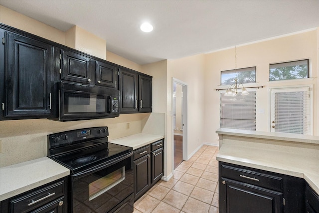 4056 La Costa Ct, Irving, TX 75038 - kitchen featuring black appliances, dark cabinets, light countertops, light tile patterned floors, and decorative light fixtures