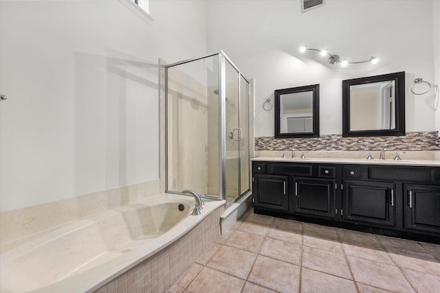 4056 La Costa Ct, Irving, TX 75038 - bathroom featuring a shower stall, double vanity, a bath, and backsplash