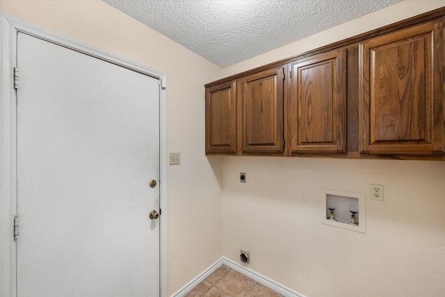4056 La Costa Ct, Irving, TX 75038 - laundry area with electric dryer hookup, cabinet space, hookup for a washing machine, a textured ceiling, and light tile patterned floors