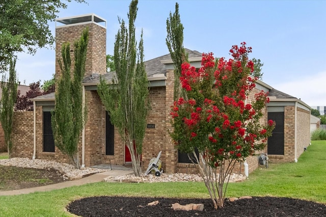 4056 La Costa Ct, Irving, TX 75038 - view of front facade featuring a chimney, brick siding, and a front yard