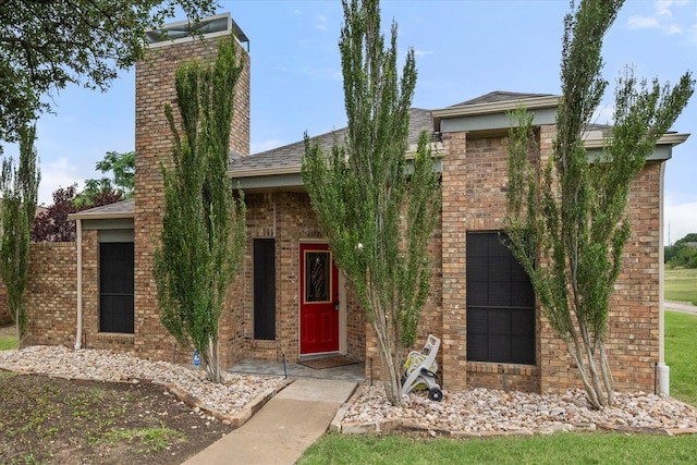 4056 La Costa Ct, Irving, TX 75038 - view of front facade with a chimney, brick siding, and roof with shingles