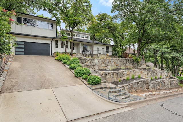 2822 Harvest Hill Dr, Grapevine, TX 76051 - view of front of house with concrete driveway, a garage, stairway, and a porch