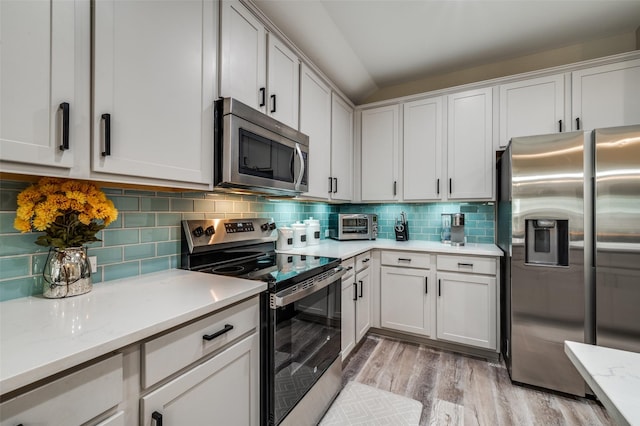 1289 Lasso Dr, Little Elm, TX 75068 - kitchen featuring stainless steel appliances, light wood-type flooring, backsplash, white cabinets, and light stone counters