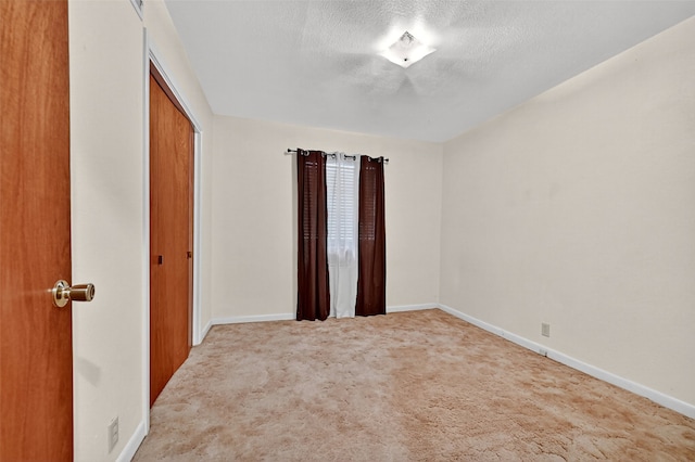 1402 Hillcrrest Dr, Sherman, TX 75092 - spare room featuring a textured ceiling and carpet flooring