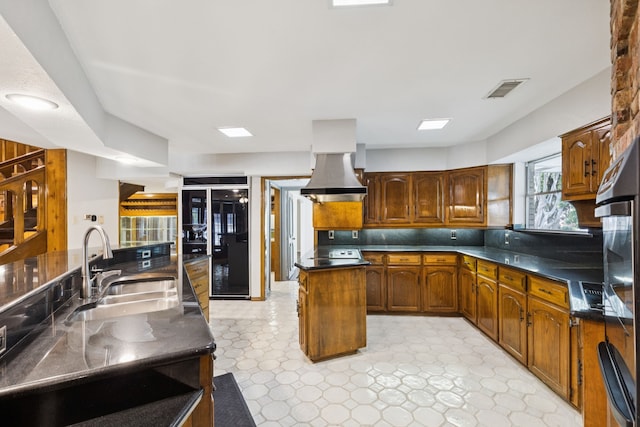 1605 Canyon Oaks Dr, Irving, TX 75061 - kitchen featuring island exhaust hood, a center island, dark countertops, fridge, and light floors