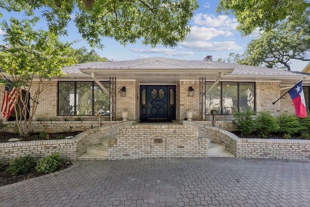 1605 Canyon Oaks Dr, Irving, TX 75061 - view of front of property featuring brick siding, a porch, and a shingled roof