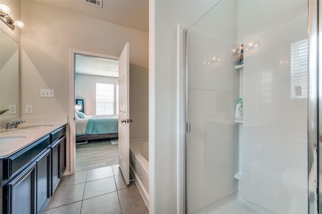 3133 Montserrat Creek Dr, Little Elm, TX 75068 - ensuite bathroom with double vanity, a shower stall, tile patterned floors, and a bath