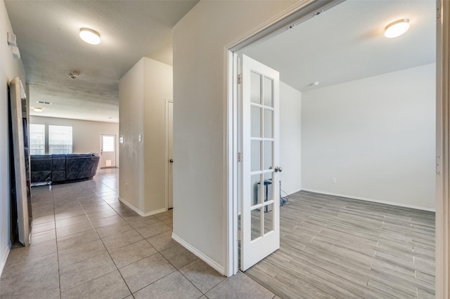 3133 Montserrat Creek Dr, Little Elm, TX 75068 - hall with french doors and light tile patterned floors