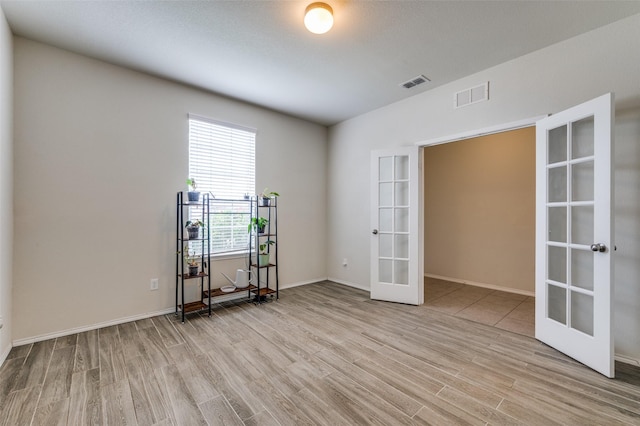 3133 Montserrat Creek Dr, Little Elm, TX 75068 - spare room featuring french doors and light wood-style flooring