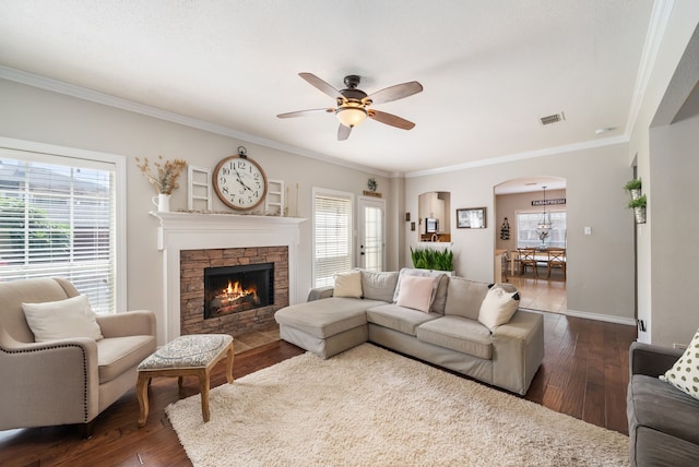 8571 Hidden Spring Dr, Frisco, TX 75034 - living room with a ceiling fan, dark wood-style flooring, arched walkways, crown molding, and plenty of natural light