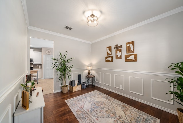 8571 Hidden Spring Dr, Frisco, TX 75034 - living area featuring ornamental molding, wood finished floors, and a wainscoted wall