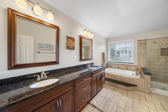 8571 Hidden Spring Dr, Frisco, TX 75034 - full bath featuring a bath, double vanity, a stall shower, and lofted ceiling