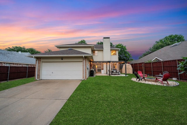 8571 Hidden Spring Dr, Frisco, TX 75034 - view of front facade featuring an outdoor fire pit, brick siding, a fenced backyard, and a chimney