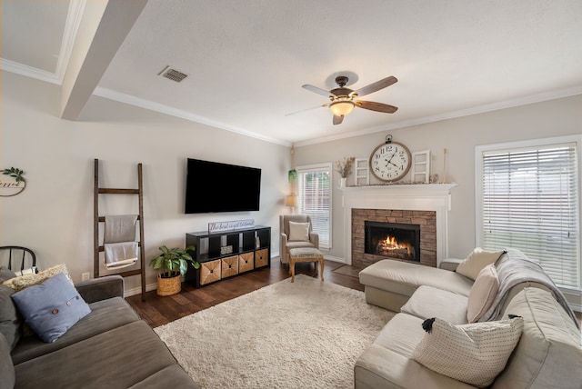 8571 Hidden Spring Dr, Frisco, TX 75034 - living area with a ceiling fan, ornamental molding, wood finished floors, and a stone fireplace