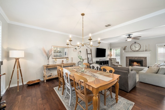 8571 Hidden Spring Dr, Frisco, TX 75034 - dining room featuring a fireplace, dark wood finished floors, ornamental molding, ceiling fan, and a chandelier