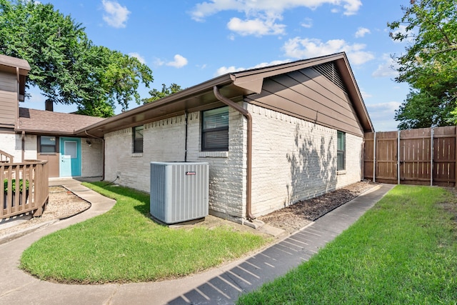 2912 Marsann Ln, Farmers Branch, TX 75234 - view of side of property featuring a central AC unit and brick siding