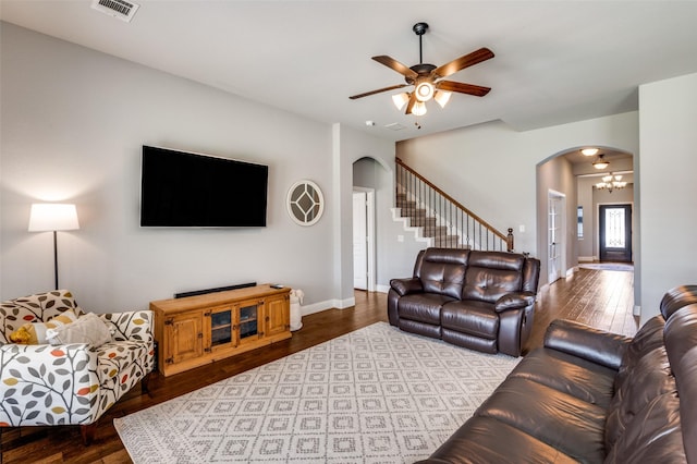 1116 Broken Wheel Trl, Aubrey, TX 76227 - living area featuring arched walkways, a ceiling fan, dark wood finished floors, and stairs