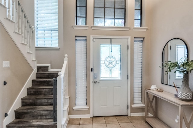 8813 Greenwood Trl, Rowlett, TX 75088 - entrance foyer featuring light tile patterned flooring, stairs, and a towering ceiling