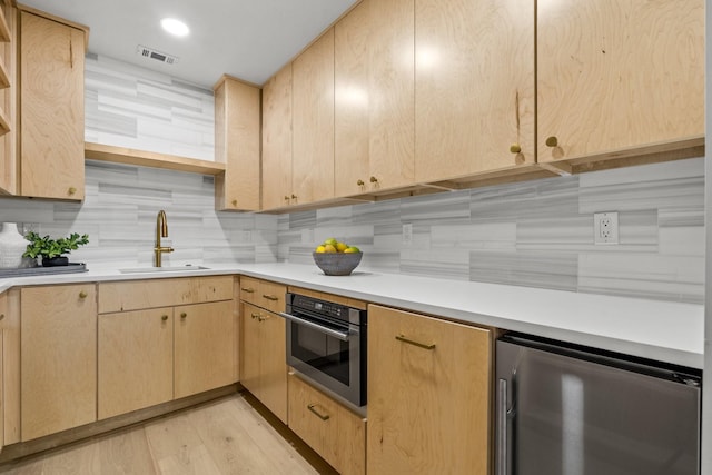 4408 Thunder Rd, Dallas, TX 75244 - kitchen with light brown cabinetry, refrigerator, light countertops, and light wood finished floors