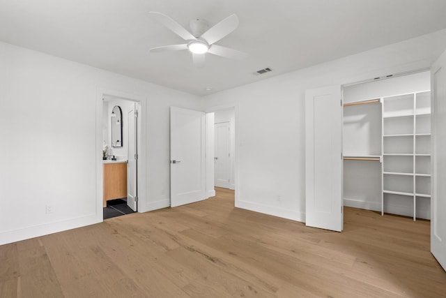 4408 Thunder Rd, Dallas, TX 75244 - unfurnished bedroom with light wood finished floors, a spacious closet, ensuite bath, a ceiling fan, and a closet