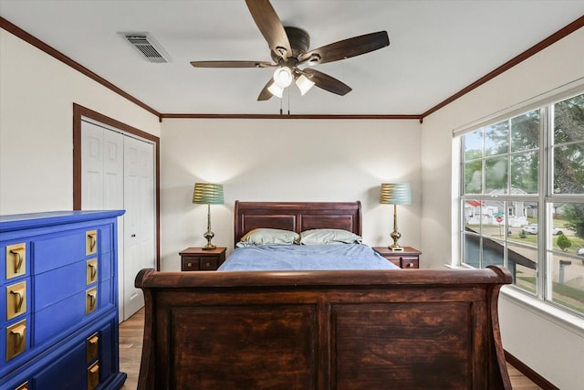 2210 Nantucket Village Cir, Dallas, TX 75227 - bedroom featuring light wood finished floors, ornamental molding, ceiling fan, and a closet