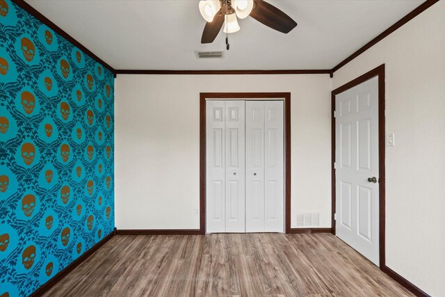 2210 Nantucket Village Cir, Dallas, TX 75227 - unfurnished bedroom with wood finished floors, crown molding, ceiling fan, and a closet