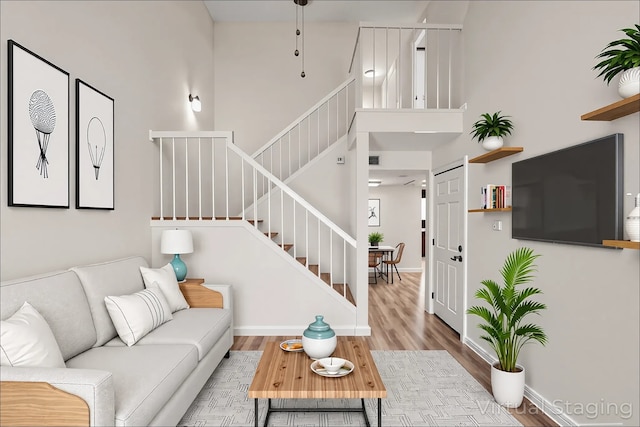 2210 Nantucket Village Cir, Dallas, TX 75227 - living area featuring a towering ceiling, stairs, and wood finished floors