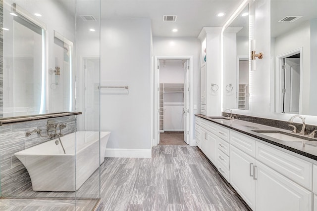 11334 Graceland Ln, Frisco, TX 75033 - full bathroom with a soaking tub, double vanity, a walk in closet, recessed lighting, and a shower