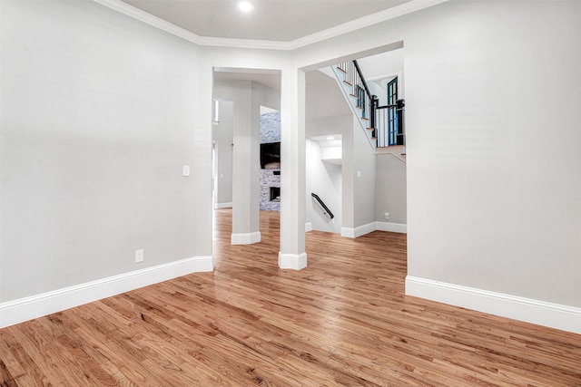 11334 Graceland Ln, Frisco, TX 75033 - empty room featuring light wood finished floors, stairs, and crown molding