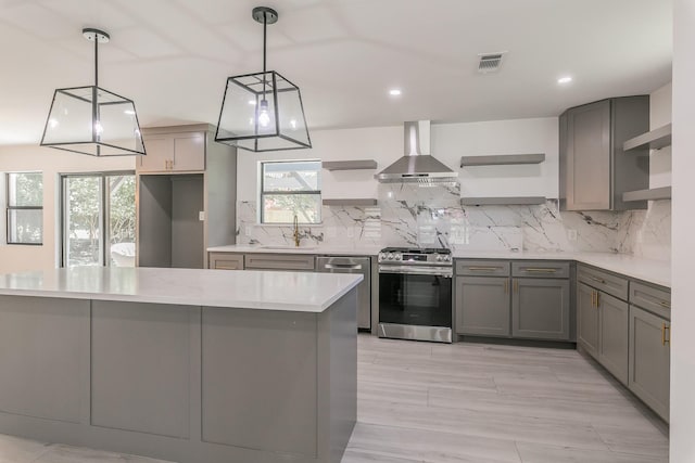 13516 Spring Grove Ave, Dallas, TX 75240 - kitchen with open shelves, wall chimney range hood, stainless steel appliances, gray cabinets, and recessed lighting