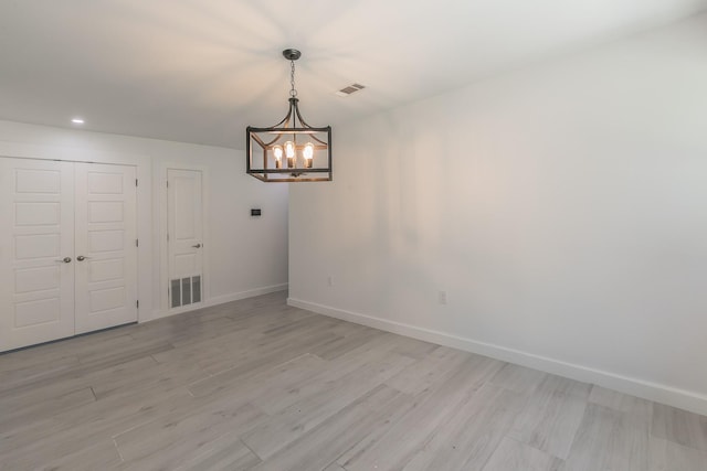 13516 Spring Grove Ave, Dallas, TX 75240 - unfurnished dining area with a chandelier, light wood finished floors, and recessed lighting
