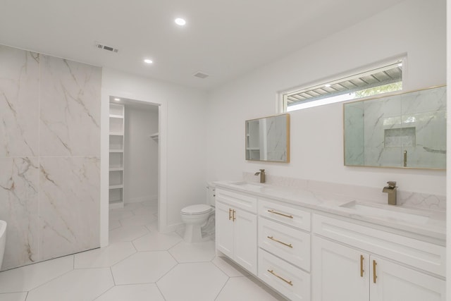 13516 Spring Grove Ave, Dallas, TX 75240 - full bath featuring double vanity, recessed lighting, a marble finish shower, a spacious closet, and tile walls