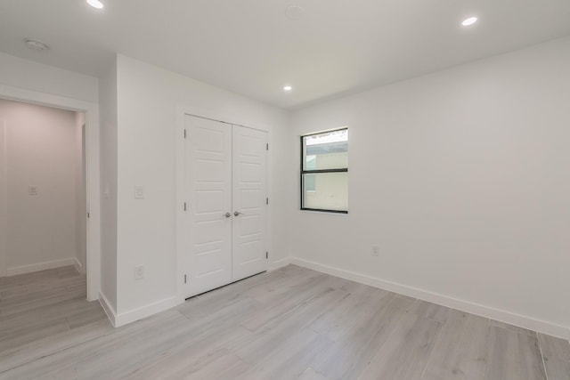 13516 Spring Grove Ave, Dallas, TX 75240 - unfurnished bedroom with light wood-style floors, recessed lighting, and a closet