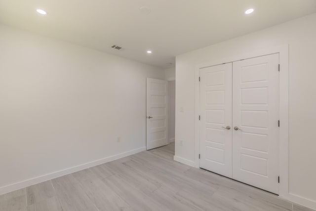 13516 Spring Grove Ave, Dallas, TX 75240 - unfurnished bedroom with light wood-type flooring, recessed lighting, and a closet