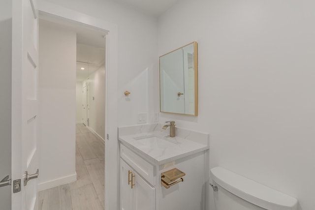 13516 Spring Grove Ave, Dallas, TX 75240 - half bath featuring vanity and wood finished floors