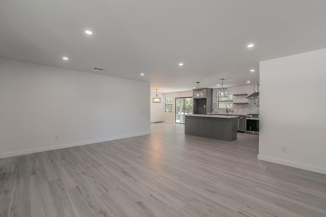 13516 Spring Grove Ave, Dallas, TX 75240 - unfurnished living room featuring recessed lighting and light wood-style floors