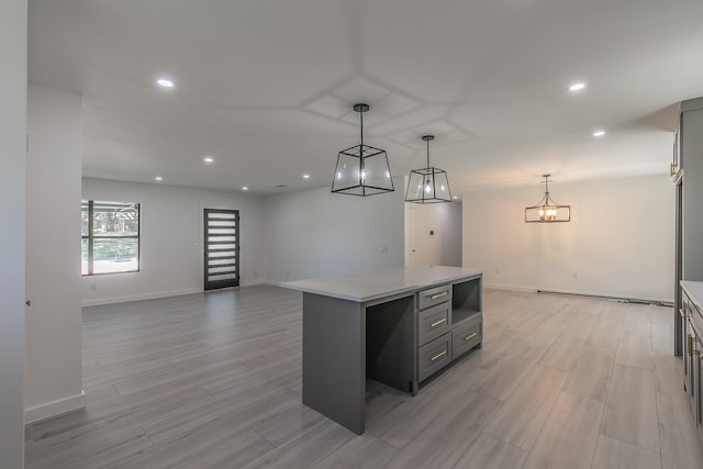 13516 Spring Grove Ave, Dallas, TX 75240 - kitchen featuring gray cabinets, light countertops, recessed lighting, light wood finished floors, and a kitchen island
