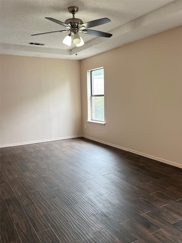 1429 Keisa Ln, Irving, TX 75060 - unfurnished room featuring dark wood finished floors, a ceiling fan, and a textured ceiling