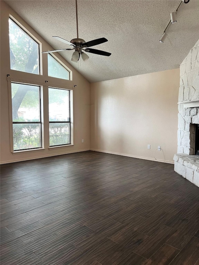 1429 Keisa Ln, Irving, TX 75060 - unfurnished living room with a textured ceiling, lofted ceiling, dark wood finished floors, a fireplace, and ceiling fan