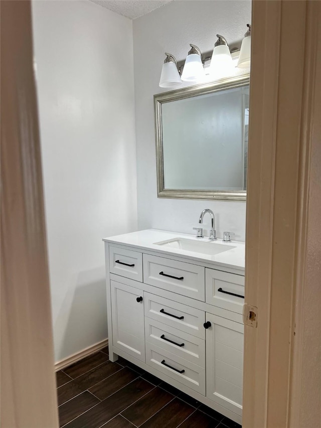 1429 Keisa Ln, Irving, TX 75060 - bathroom with vanity, wood finished floors, and a textured ceiling