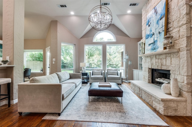 1016 Hanover Dr, Southlake, TX 76092 - living area featuring a chandelier, a stone fireplace, wood finished floors, healthy amount of natural light, and vaulted ceiling